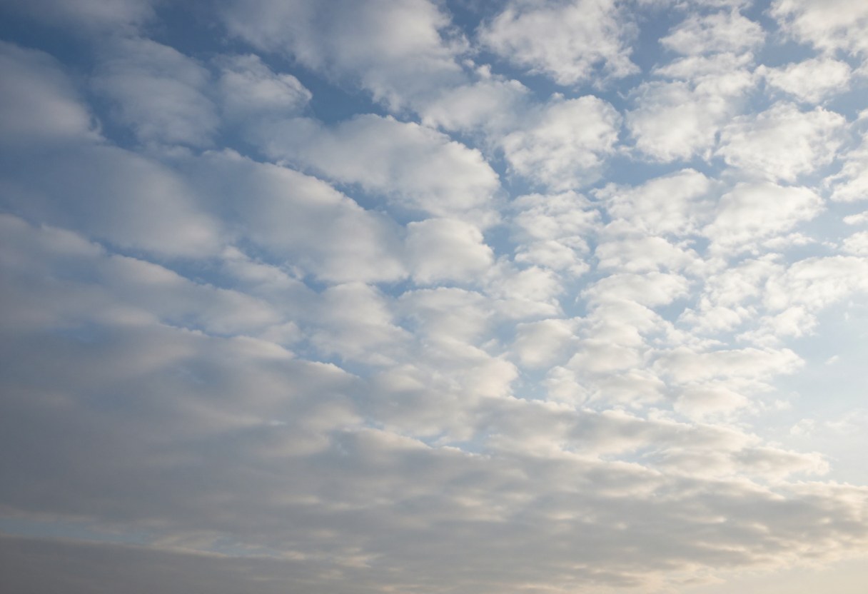 Photo-style AI-generated image of altocumulus clouds: rows of white and gray cotton-wool patches across a pale blue sky